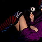 First pic of Teen solo girl with dyed hair and piercings bares her tits while licking candy