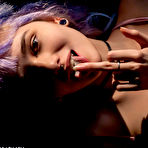 Third pic of Teen solo girl with dyed hair and piercings bares her tits while licking candy