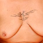 Third pic of Big busted blonde granny stripping off her lingerie on the bed