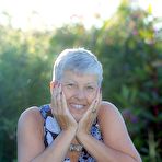 Fourth pic of Silver haired granny Savana gets naked outdoors on a blanket in stockings