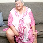 First pic of Horny Grandma Libby strips and spreads her old shaved pussy on the sofa
