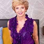 First pic of Blonde granny Romana finger spreads her hairless pussy on a bed