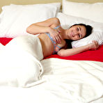 First pic of Young brunette Liz Jordan fingers and dildos her pussy on a bed