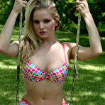 First pic of Young blonde girl starts to take off her bikini top on a swingset