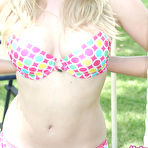 Third pic of Young blonde girl starts to take off her bikini top on a swingset