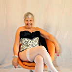 First pic of Granny first timer Savana holds her bare ass after pulling down a thong