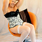 Second pic of Granny first timer Savana holds her bare ass after pulling down a thong