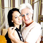 First pic of Horny granny and her teen lover kiss before lesbian sex commences