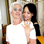 Second pic of Horny granny and her teen lover kiss before lesbian sex commences