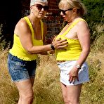 First pic of Old lesbians bare their butts and twats in a field while wearing sunglasses