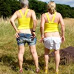 Third pic of Old lesbians bare their butts and twats in a field while wearing sunglasses